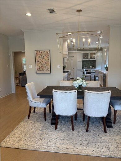 Dining area with a chandelier, ornamental molding,