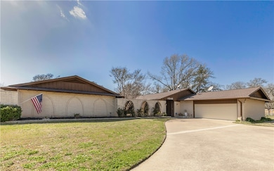 View of front of house with brick siding, driveway