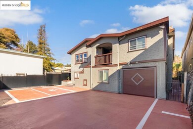 View of front of property featuring a balcony, an attached garage, and stucco siding