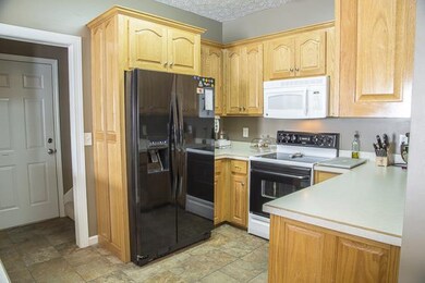 Kitchen has tile floor, built-in microwave and ref