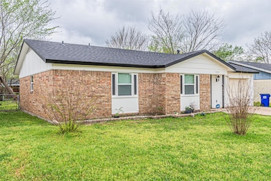 Single story home featuring a front yard, brick si