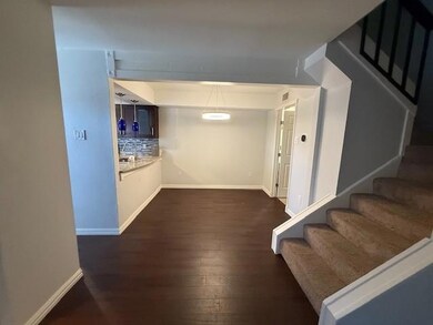 Hallway featuring dark wood-type flooring