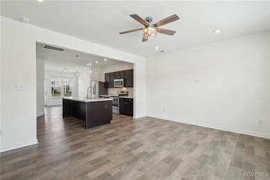 Kitchen with stainless steel appliances, open floo