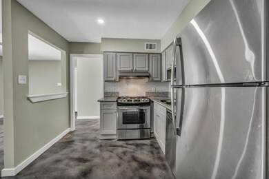 Kitchen featuring stainless steel appliances, gra