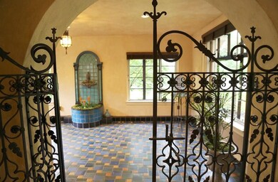 The ornate wrought iron gates beckon you to the he