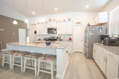 Kitchen featuring a breakfast bar, light wood fini