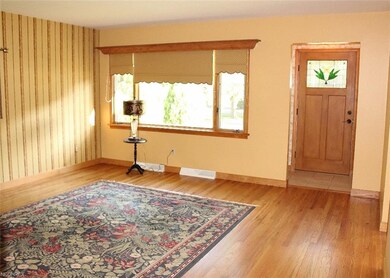 Living room with immaculate wood floor and custom 