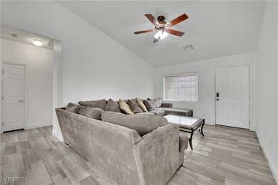 Living room featuring ceiling fan, visible vents,