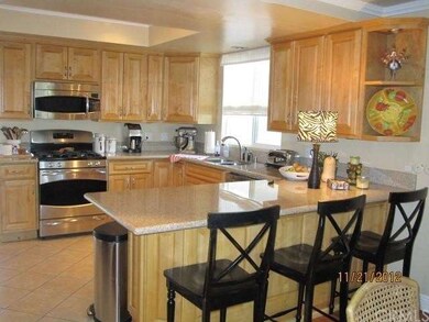 KITCHEN WITH GRANITE COUNTERS AND BREAKFAST BAR