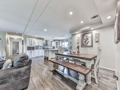 Dining space with wood finished floors, recessed lighting, and crown molding