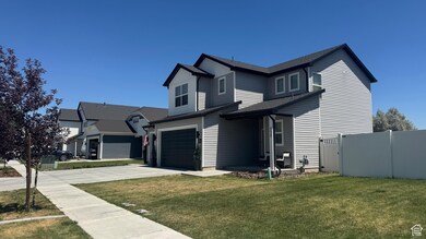 View of front of home with an attached garage, driveway, and a shingled roof