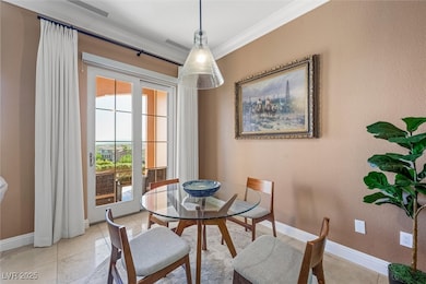 Tiled dining room with crown molding, french doors, and a textured wall