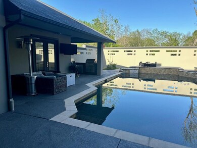 Pool featuring a patio and exterior kitchen