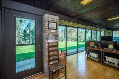 The 4 season room includes a Franklin Stove and th