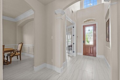 Entrance foyer with arched walkways, visible vents