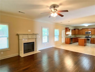 Unfurnished living room with ornamental molding, c