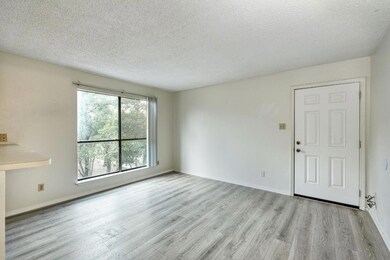 Unfurnished living room with wood finished floors