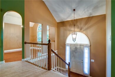NATURAL LIGHT POURS INTO THE FOYER THROUGH THE WINDOWS THAT SURROUND THE FRONT DOOR.