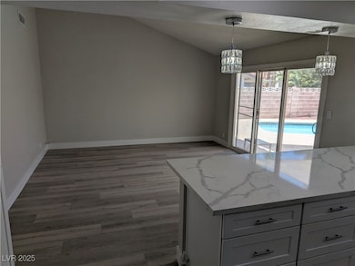 Unfurnished dining area with a chandelier, wood fi