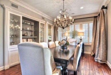 Formal dining room with built-in and custom draper