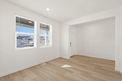 Empty room featuring light wood-style floors and recessed lighting