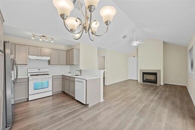 Kitchen featuring gray cabinetry, under cabinet r