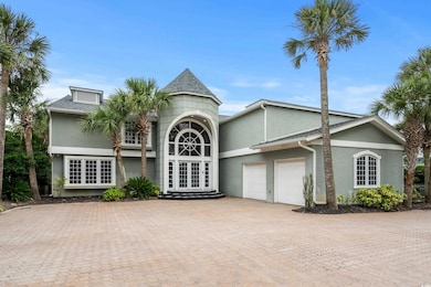 View of front of property featuring a garage and f