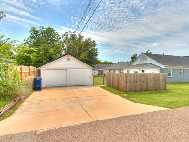 Garage featuring a lawn