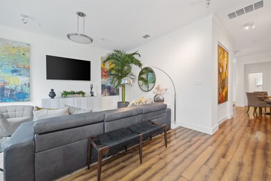 Living room featuring crown molding and wood finished floors