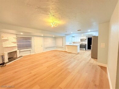 Unfurnished living room with light wood finished f