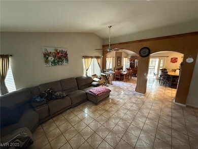 Living area featuring arched walkways, lofted ceil