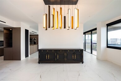 Another view of the formal dining room reveals its open connection to the kitchen, creating an inviting flow ideal for entertaining. The space beautifully showcases the home’s blend of elegance and functionality, where design and practicality meet.
