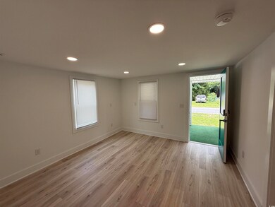 Unfurnished room with light wood finished floors, recessed lighting, baseboards, and a smoke detector