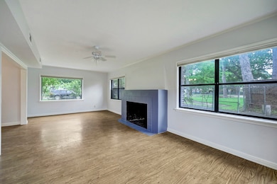 fireplace, wood floors and lots of windows