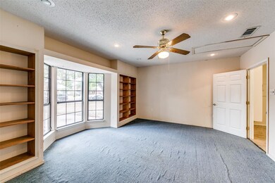 Family Room with built in shelves, carpet, a textu