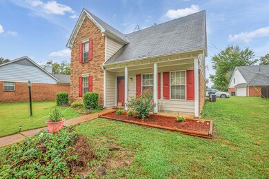 View of property featuring a front lawn