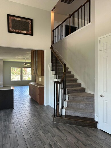 Stairway with a towering ceiling, wood finished f
