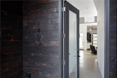 The front exterior facade is hand charred wood usi