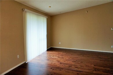 Living room with new wood floors and vaulted ceili