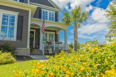 View of exterior entry featuring a porch and board and batten siding
