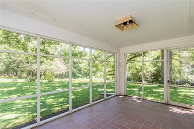 Tiled screen porch with garden and woodland views