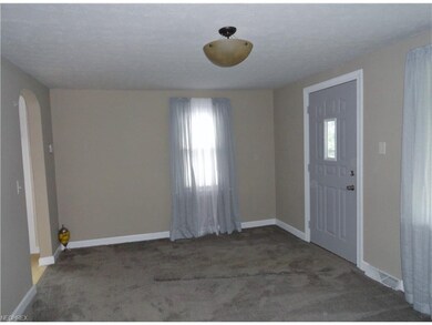 Living room archway leads to the kitchen