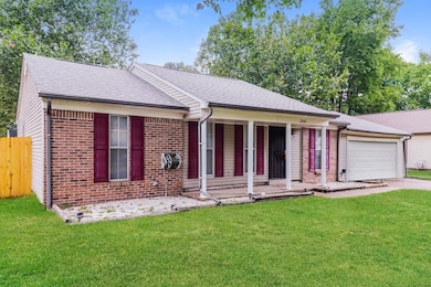Ranch-style house with roof with shingles, brick siding, a porch, and driveway