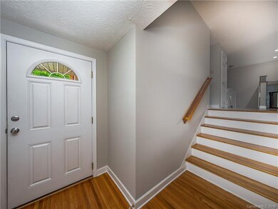 Fresh paint and newly refinished floors create a w