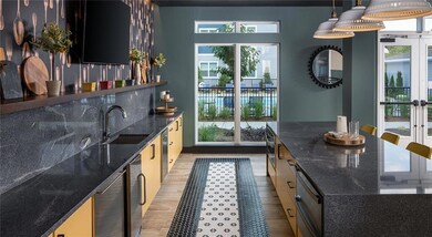 Kitchen featuring french doors, healthy amount of natural light, a kitchen island, and light wood-style flooring