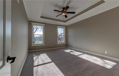 Spacious master suite with double windows and ceil