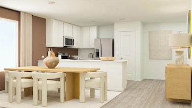 Kitchen with white cabinetry, light wood-type floo