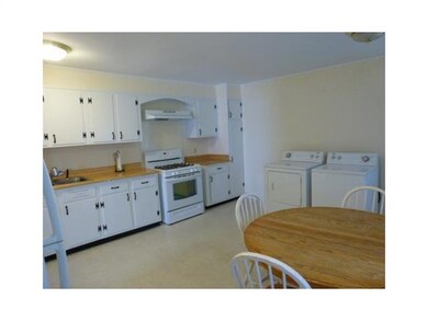 Kitchen. Eat-in Kitchen has an abundance of cabinets, range/oven, refrigerator and washer & dryer