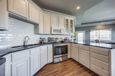 Kitchen featuring kitchen peninsula, appliances wi