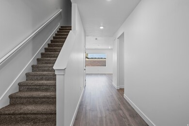 Stairway featuring wood finished floors and recessed lighting